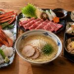 松葉がに、二十世紀梨、砂丘らっきょうなど鳥取県の定番名物を並べた食卓